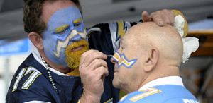 San Diego Chargers fan Bob Paulstring, left, works on some face paint for Ken Bruns before the Chargers face the Green Bay Packers in an NFL football game Sunday, Nov. 6, 2011, in San Diego. (AP Photo/Denis Poroy)